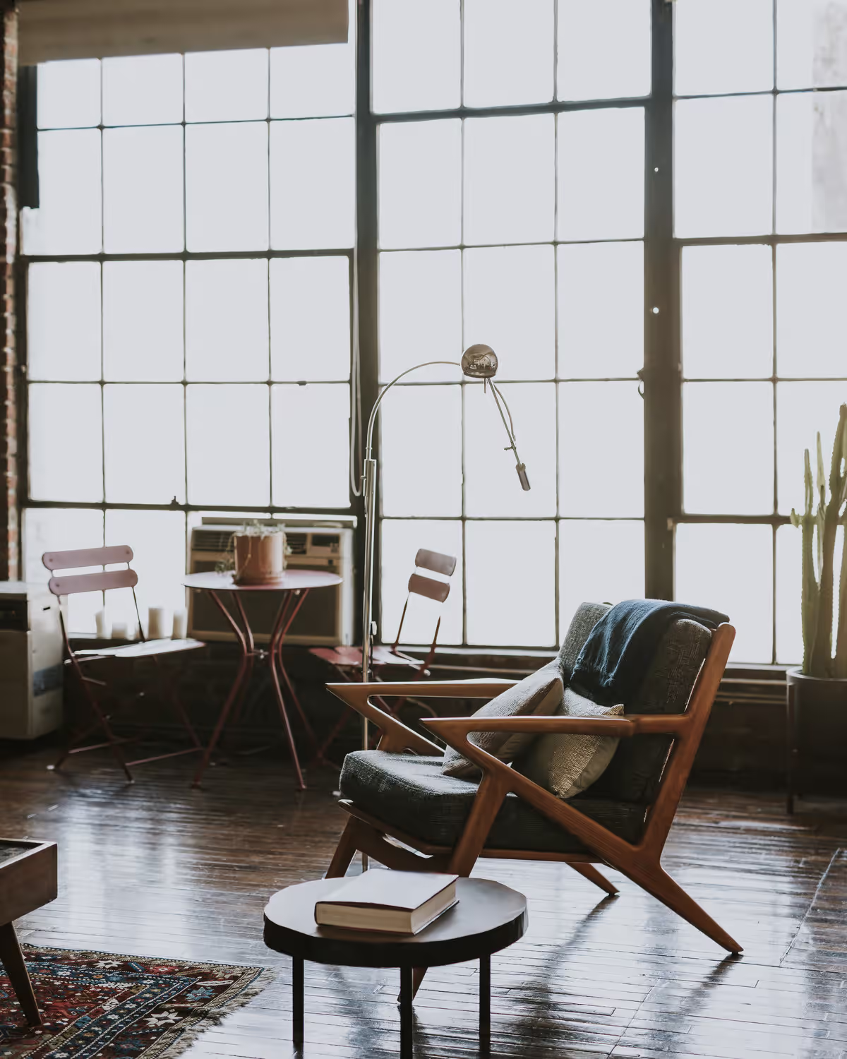 Lounge chair by tall windows, no people