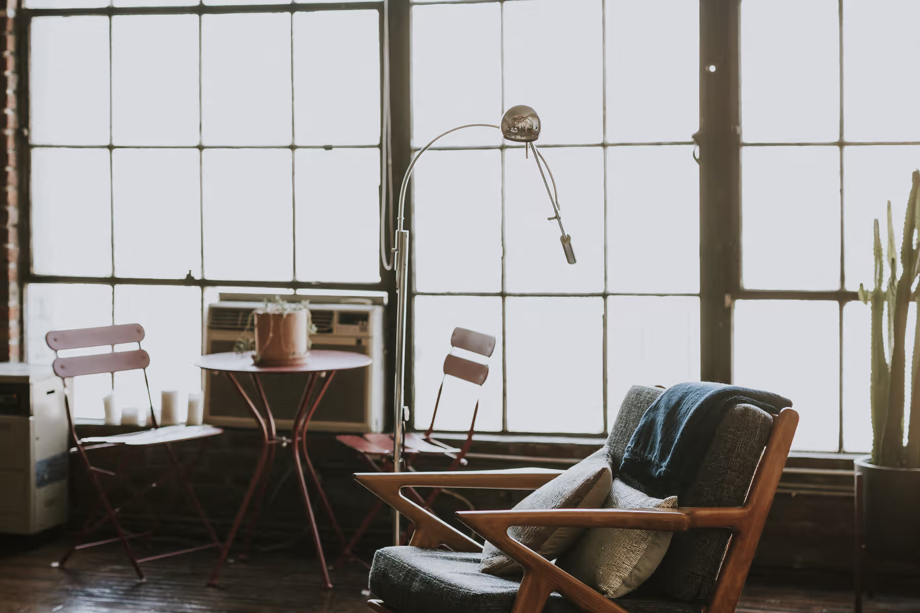 Lounge chair by tall windows, no people