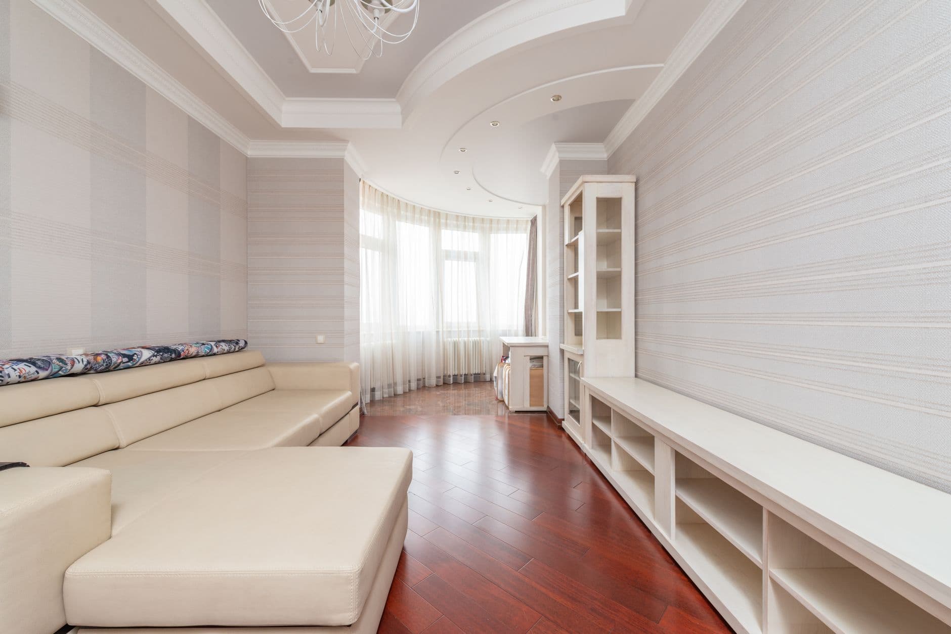Pale dining room with timber floor, chairs and generous circulation space