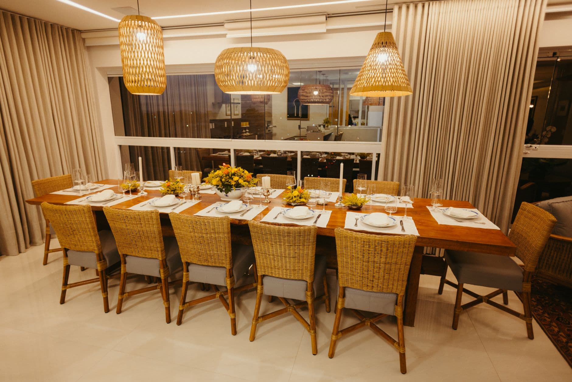 Dining chair with a hand-woven natural fibre seat beside a timber table