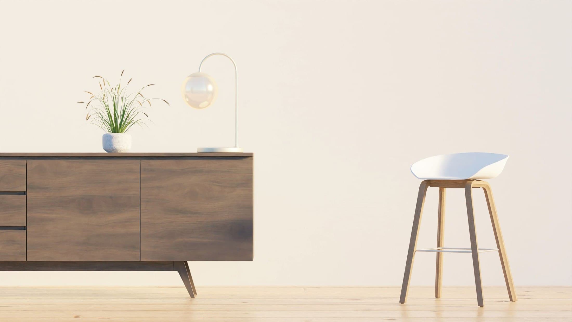 Dark wooden sideboard and a pale chair against a light wall
