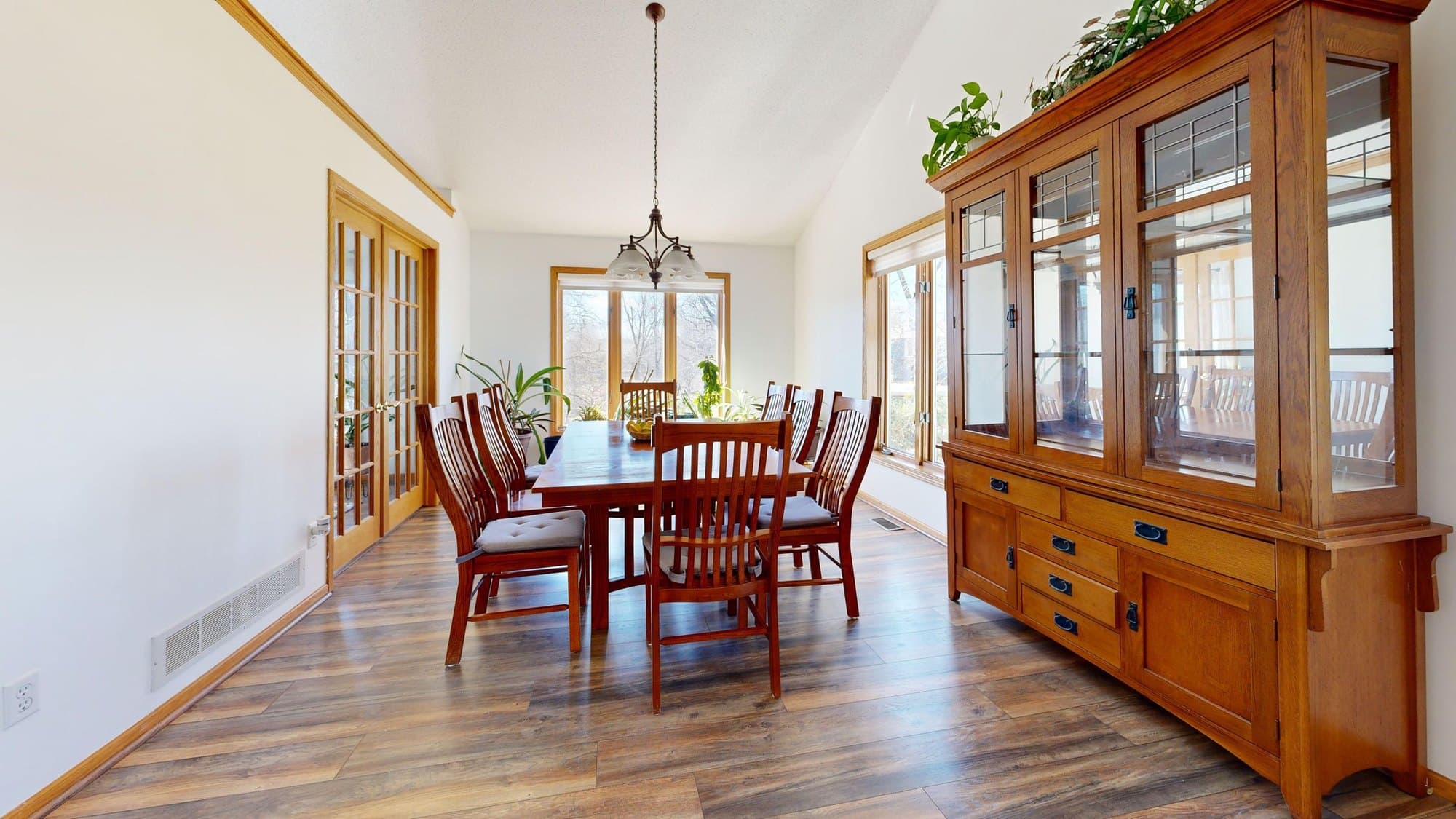 Light oak dining table and chairs in a pale contemporary room
