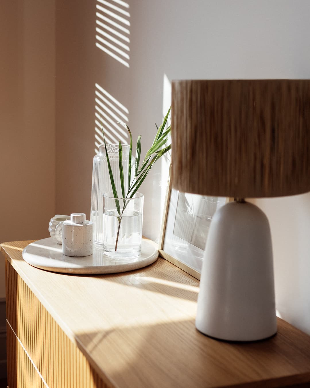 Wood shade table lamp on an oak chest in sunlight