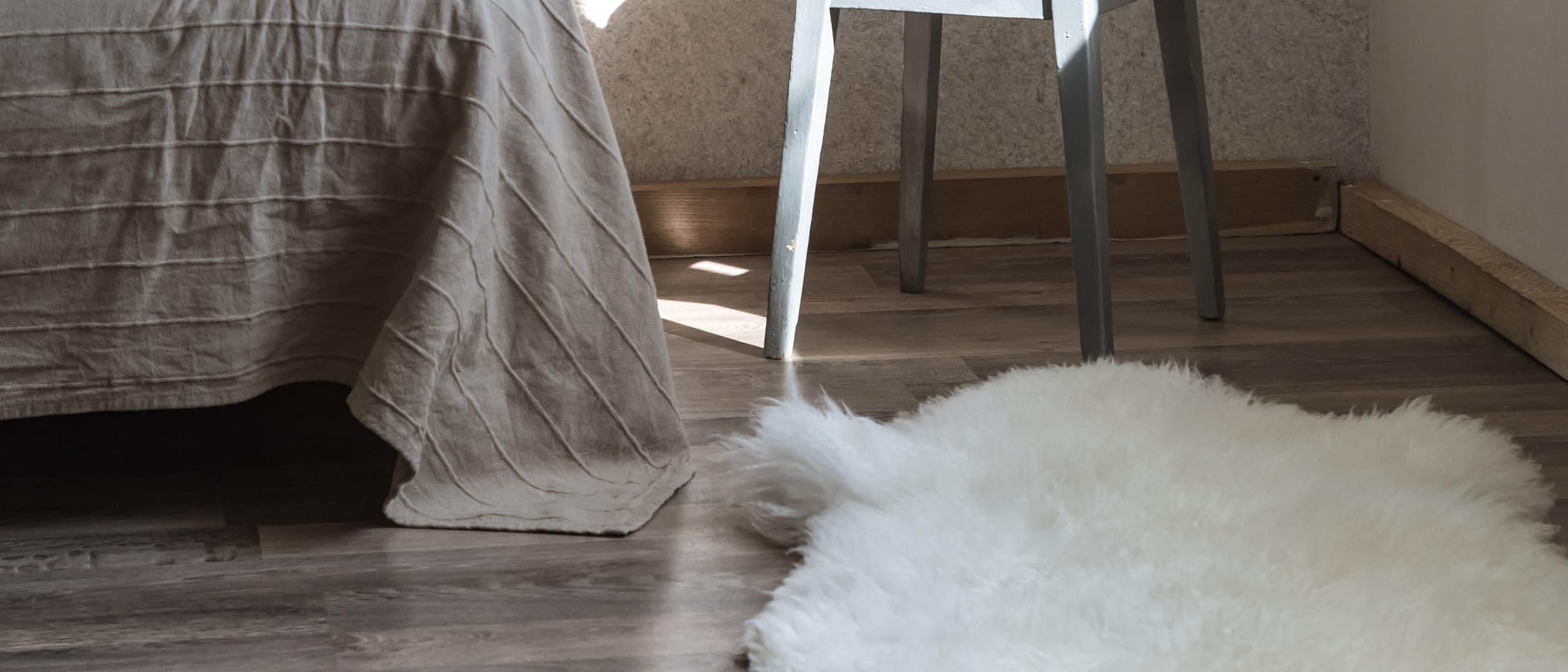 Round knit rug on a herringbone wood floor