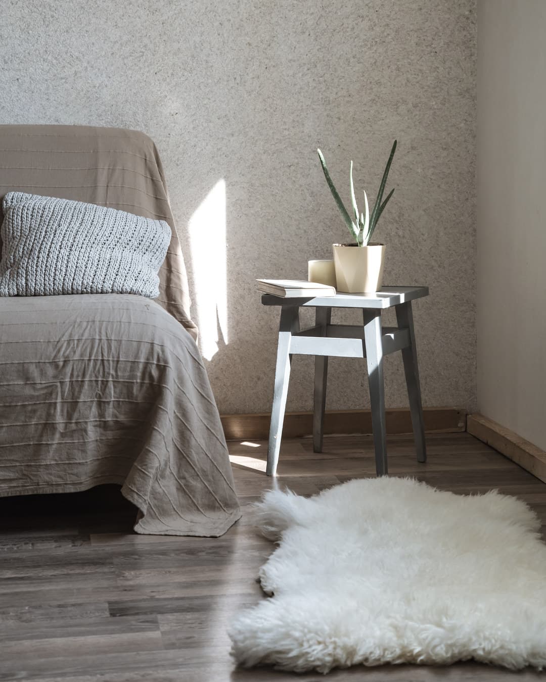 Round knit rug on a herringbone wood floor