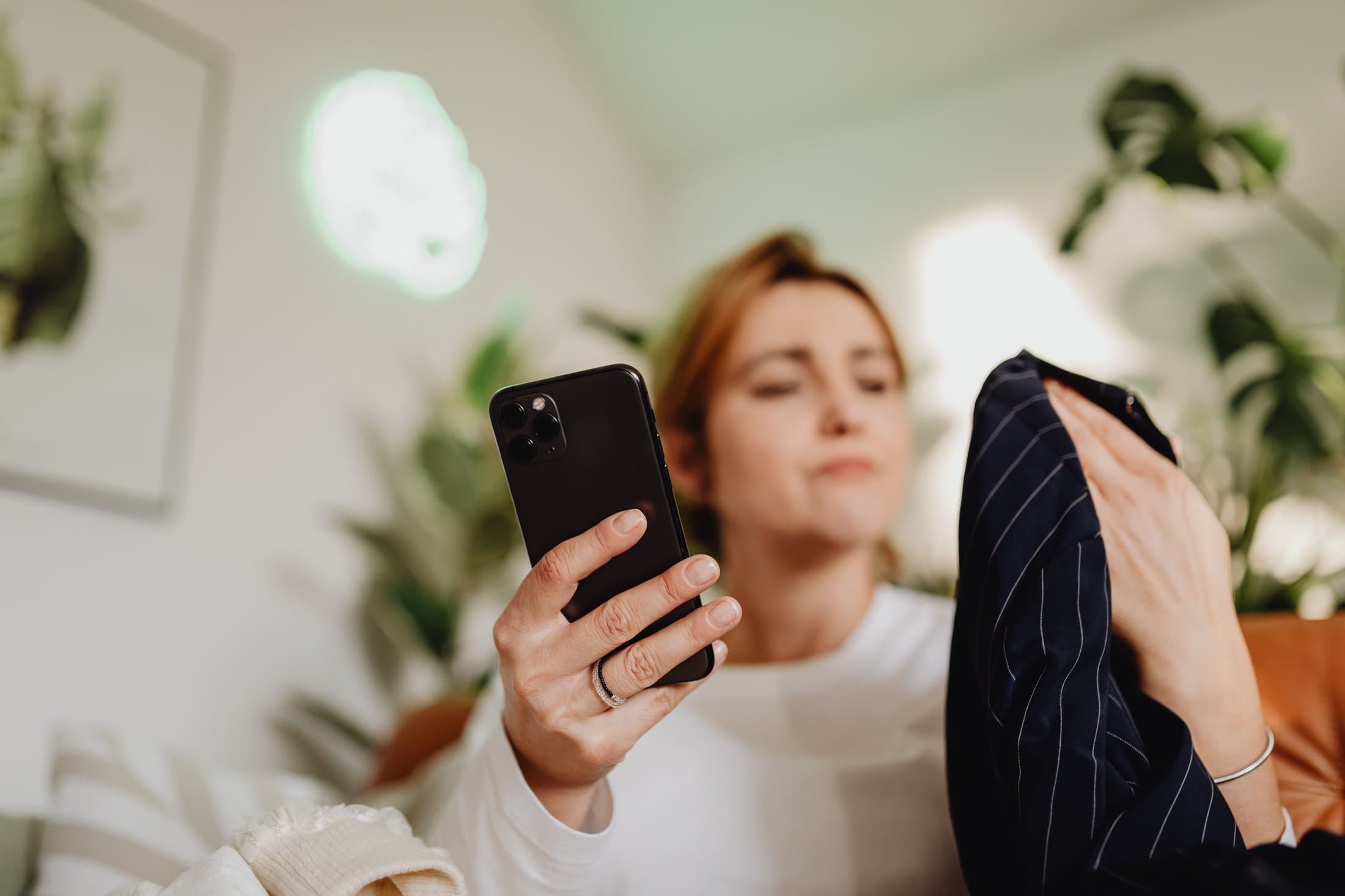 Person comparing fabric with an online listing on a phone