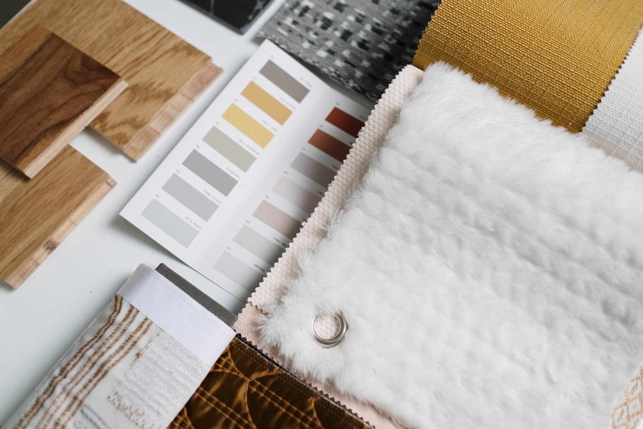Interior material samples with fabric, timber and neutral colour chips