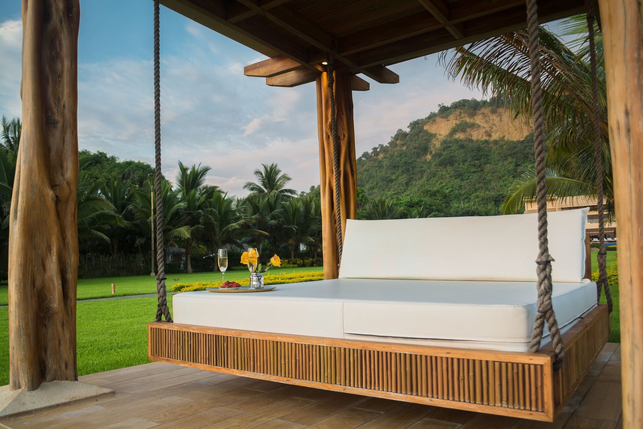 Wood-framed outdoor daybed with a white mattress